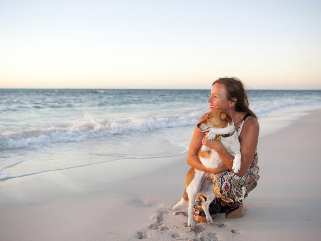 Woman on beach with dog