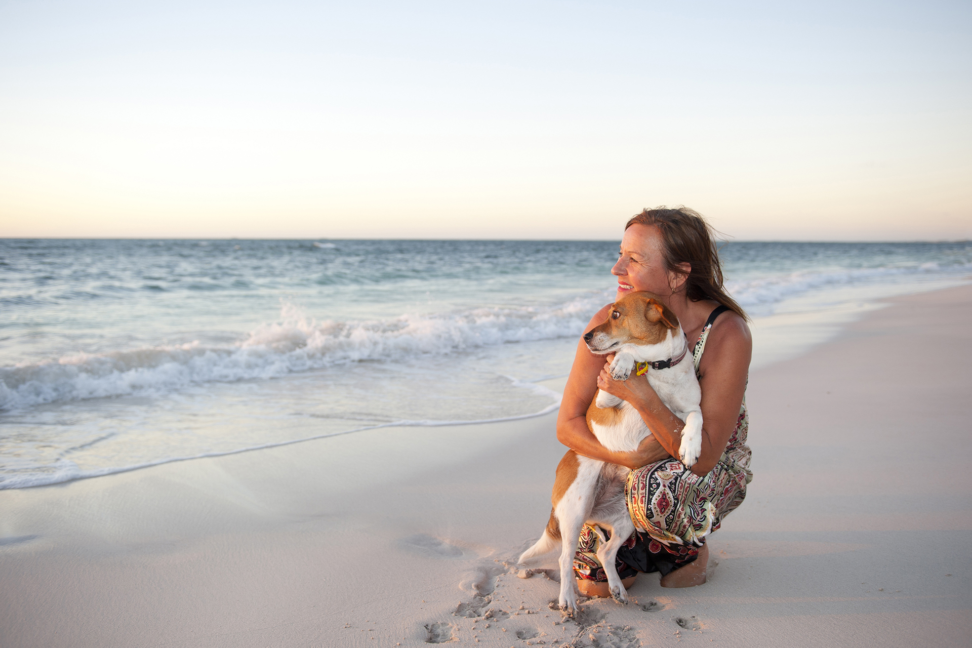 Woman on beach with dog